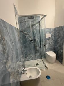 a bathroom with a shower and a sink and a toilet at Angelo in Futani