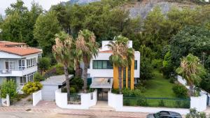 an aerial view of a white house with palm trees at Villa Diva in Kemer