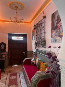 a living room with a couch and a chandelier at Dar Mora in Tangier