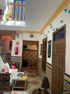 a living room with a door and a table at Dar Mora in Tangier