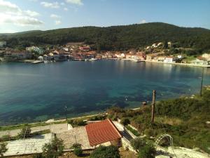 a view of a large body of water with houses at Nicolas Rooms in Fiskardo