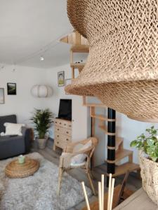 a living room with a spiral staircase and a couch at Lombfészek in Rezi