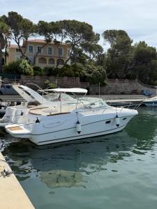 a white boat is docked in the water at Unique experience on a boat in Saint-Raphaël in Saint-Raphaël