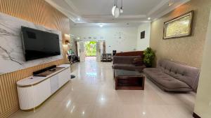 a living room with a couch and a flat screen tv at Pildacil in Garut