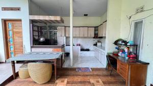 a large kitchen with a table and a counter at Pildacil in Garut