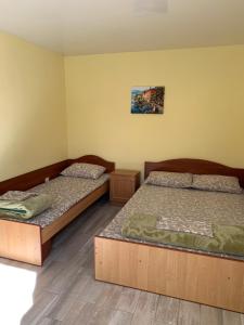 two beds in a room with twoperate beds at Mini-hotel Zefir in Zatoka