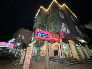 a hotel with a sign in front of a building at Hotel Radiation Deoghar in Deoghar