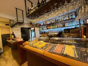 a restaurant with a counter with food on it at Casa do Theatro Guest House in Barcelos