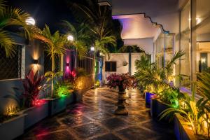 a courtyard with plants and lights in a building at Royal Beach Hotel in Trincomalee