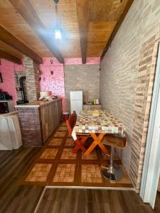 a dining room with a table and a kitchen at Village FLOWER IVY Montenegro in Nikšić