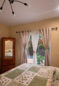 a bedroom with a bed and a window at Nandos Places in Puerto Barrios