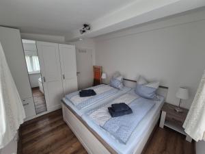 a bedroom with a bed with blue pillows on it at Antonios Hüttenzauber in Oberhof