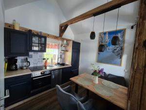 a kitchen with a wooden table in a room at Antonios Hüttenzauber in Oberhof