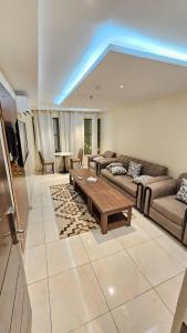 a living room with a couch and a table at فيولورين سويتس in Al Baha