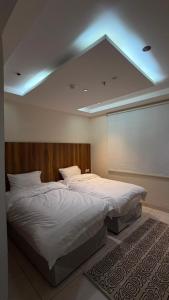 a large bed in a bedroom with a ceiling at فيولورين سويتس in Al Baha