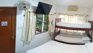 a bedroom with two bunk beds and a window at Palma Paraíso Hotel in Melgar
