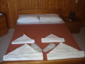 a hotel room with two beds and two pillows at Nicolas Rooms in Fiskardo
