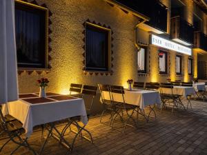 a group of tables and chairs in front of a building at ESER Hotel Restaurant in Bad Bellingen
