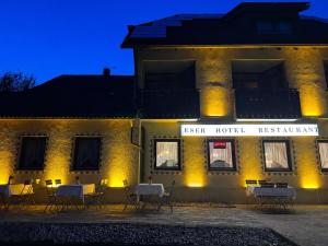a building with tables and chairs in front of it at ESER Hotel Restaurant in Bad Bellingen