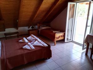 a bedroom with two beds with towels on them at Nicolas Rooms in Fiskardo