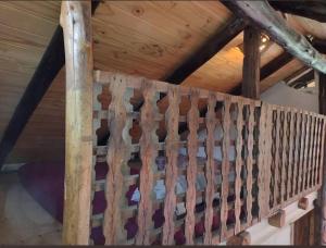 a wooden staircase in a room with a wooden ceiling at Cabaña Vallecitos in Ciudad Lujan de Cuyo