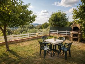 a table and chairs sitting on top of a yard at Villa Vale in Casole dʼElsa +22 photos