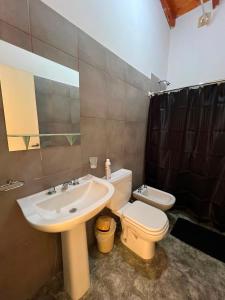 a bathroom with a sink and a toilet at Altos del Pissis I in Tinogasta