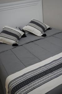 a large bed with two pillows on top of it at Casa del Pueblo in Teotitlán del Valle