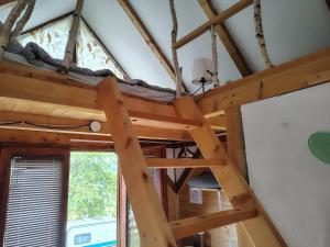 a loft bed in a room with a window at Aurora Tara 3 in Zaovine