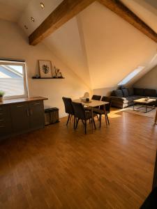 a living room with a table and chairs and a couch at Moderne Dachgeschosswohnung in Kirchlengern