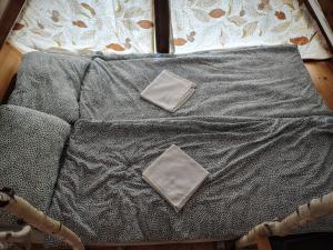 a bed with two pillows on top of it at Aurora Tara 3 in Zaovine