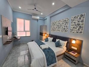 a bedroom with a large bed and a window at Hotel Vatsalya by The Holy Meander in Varanasi