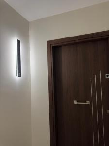 a wooden door in a room with a wall at Orelia Suite 3 in Karistos