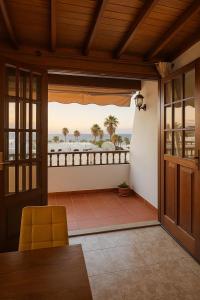 a room with a balcony with a view of the ocean at Villa Buendía in Puerto del Carmen