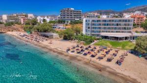 an aerial view of a beach with chairs and umbrellas at Orelia Suite 3 in Karistos