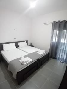 a bedroom with a bed with a tray of food on it at Panorama Palace 1 in Palasë