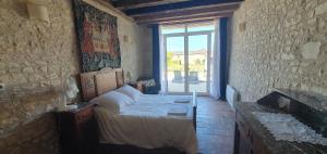 a bedroom with a bed in a room with a window at Les Fleurs de La Brise in Nueil-sous-Faye