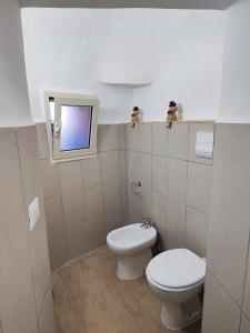 a small bathroom with a toilet and a sink at A Chera Via in Laureana Cilento
