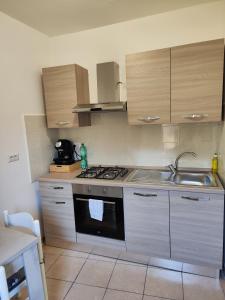 a kitchen with a stove and a sink at A Chera Via in Laureana Cilento