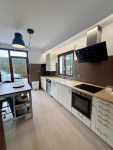 a kitchen with white cabinets and a counter top at La casa de Nino in Cabanzón