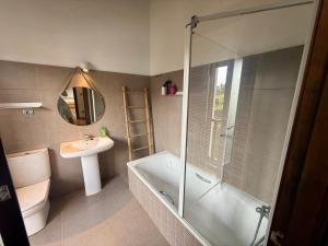 a bathroom with a shower and a sink and a toilet at La casa de Nino in Cabanzón +30 photos