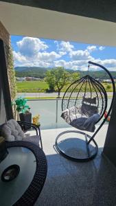 a swing sitting on a porch with a view of a balcony at Divine Luxury Rasnov in Râşnov