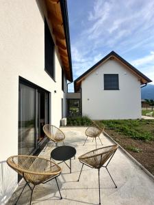 a group of chairs and tables on a patio at Sitara's Chalet in Bled