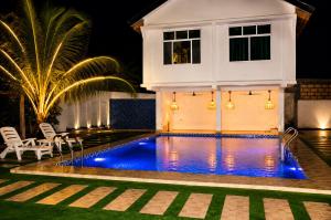 a swimming pool in front of a house at night at The lagoons resort Zanzibar in Nungwi