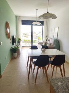 a living room with a table and a couch at ILDA MENTa in Miami Platja +8 photos