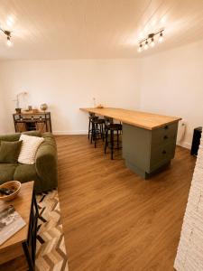 a living room with a couch and a table at Résidence de la Place in Pont-du-Château +25 photos
