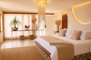 a bedroom with a large bed and a large window at Casa Elixir Boutique in Barranquilla +61 photos