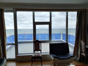 a living room with a view of the ocean at Hotel Olimp in Shekhvetili