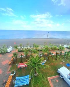 an aerial view of a beach with chairs and the ocean at Hotel Olimp in Shekhvetili