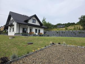 a house with a garden in front of it at Bieszczady Bóbrka 24 in Bóbrka